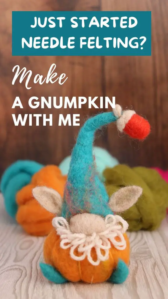 Image shows a brightly coloured needle felted pumpkin made into a gnumpkin; a gnome and pumpkin hybrid
