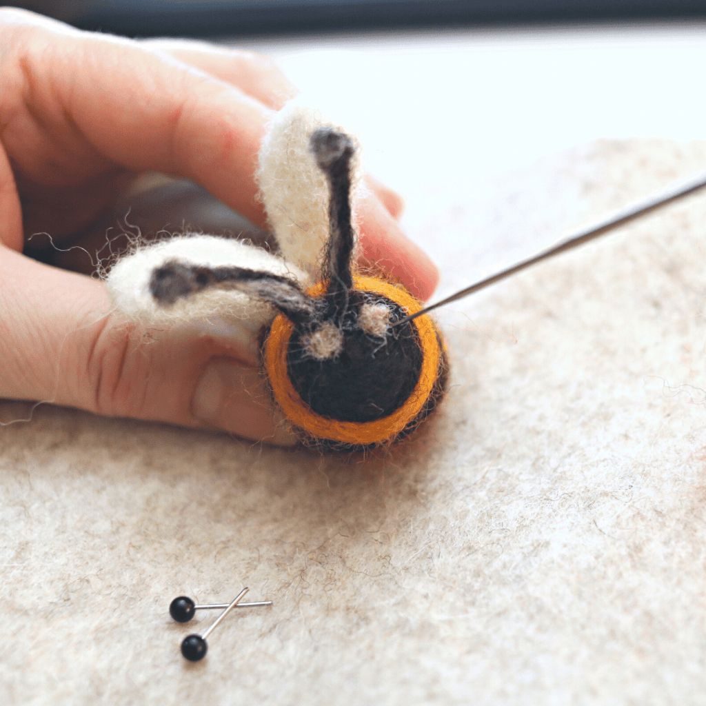 image shows how to needle felt a bumble bee