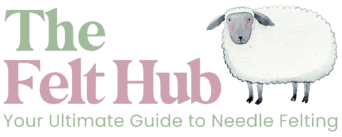 Text logo reading “The Felt Hub – Your Ultimate Guide to Needle Felting,” with “The” and “Your Ultimate Guide…” in green, “Felt Hub” in pink, and an illustrated white sheep on the right.